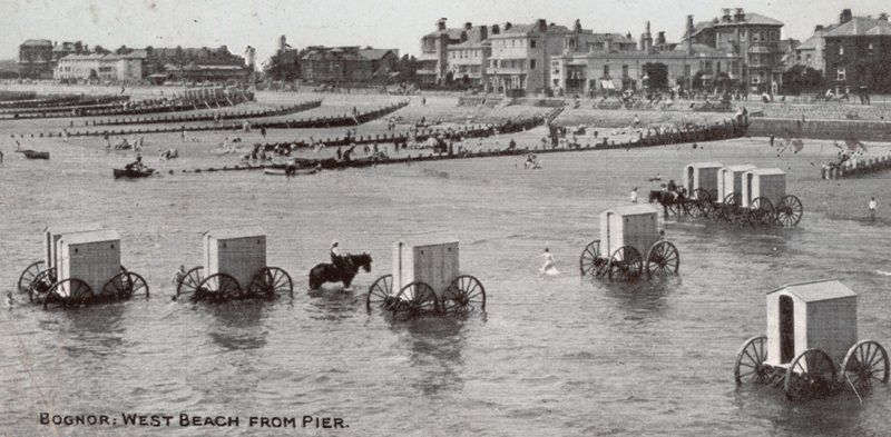 Victorian bathing machines in the water