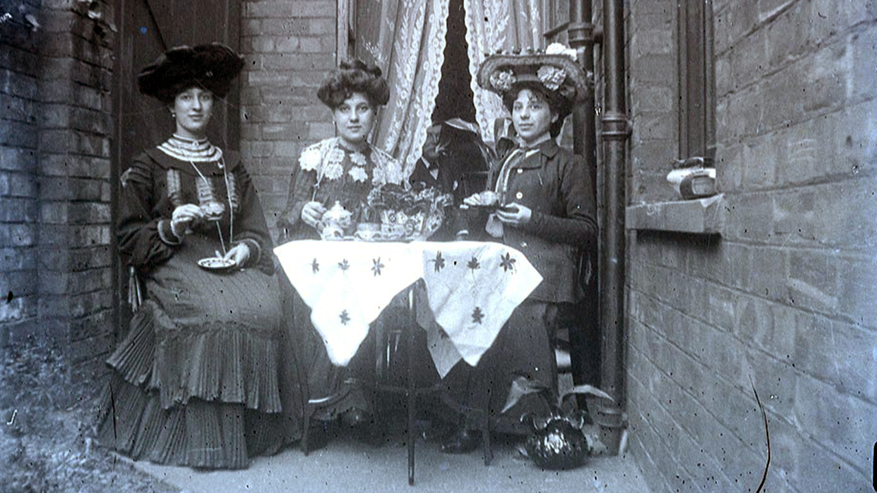 Edwardian ladies at tea wearing hats