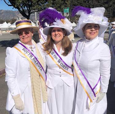 Ellen Snortland and two other walkers in the parade