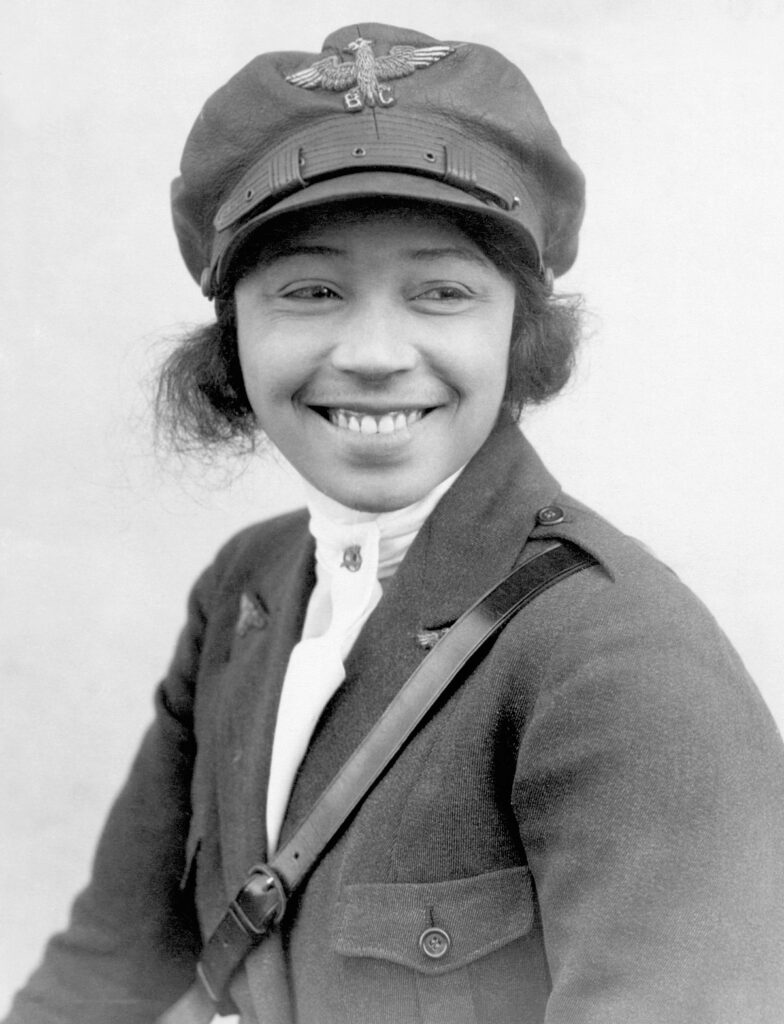 Black and white photograph of Bessie Coleman with pilot's hat